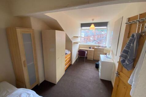 A cozy and well-maintained bedroom with natural...