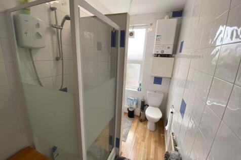 Bright and clean bathroom with a shower cabin a...