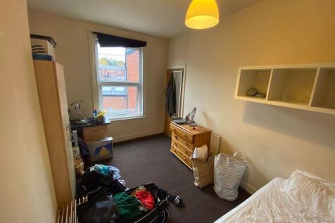 A cozy bedroom with a window bringing in natura...