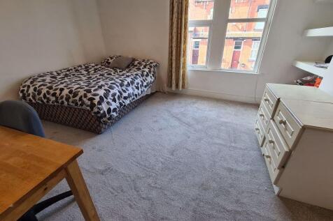 A cozy and well-maintained bedroom featuring a ...