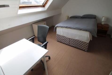 A bright and comfortable master bedroom with a ...