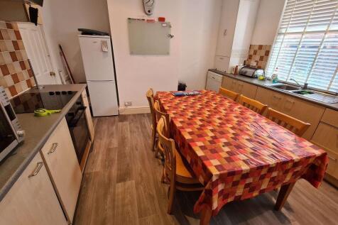 A bright and welcoming kitchen with ample natur...