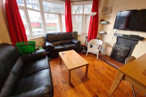 A cozy and well-lit living room featuring large...