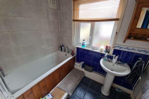 A well-maintained bathroom with a white sink an...