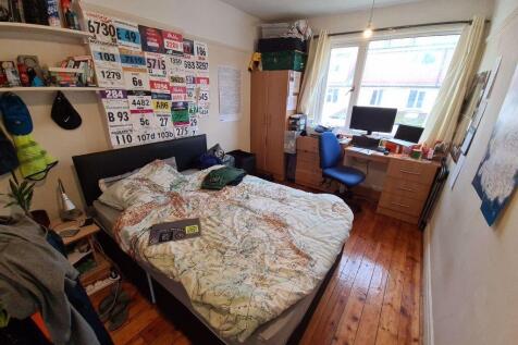 A welcoming and well-lit master bedroom featuri...