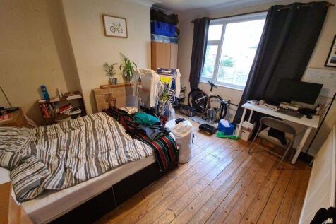 A cozy bedroom featuring a large bed, with natu...