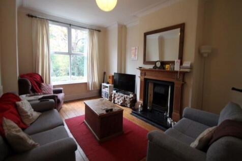 A cozy and well-lit living room featuring a com...