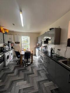 A spacious and well-lit contemporary living roo...