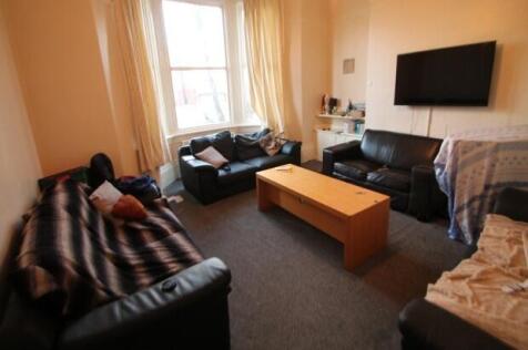 A spacious and welcoming living room with ample...