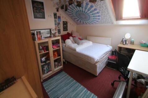 A cozy and well-maintained bedroom featuring a ...