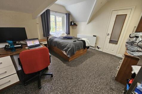 A comfortable and well-lit double bedroom featu...