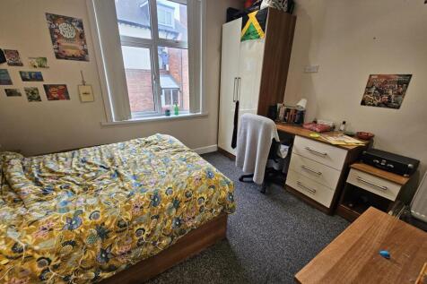 A cozy and well-maintained bedroom featuring a ...