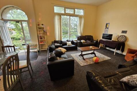 A spacious and well-lit contemporary living roo...