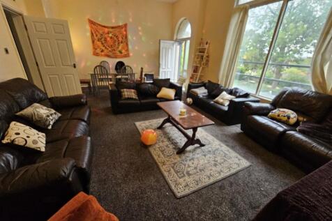 A spacious and inviting living room filled with...