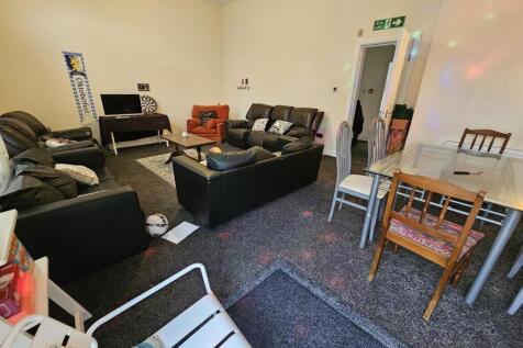 A spacious and well-maintained living room feat...