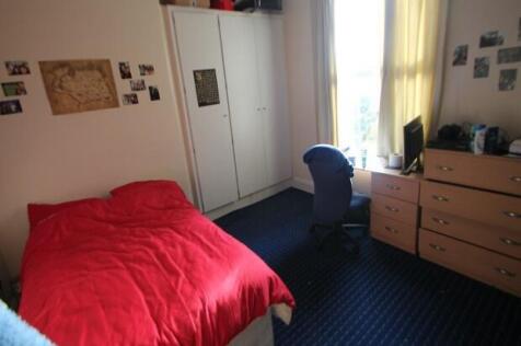 A cozy bedroom featuring a comfortable bed with...