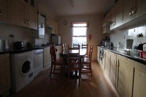 A well-lit and tidy kitchen with modern applian...