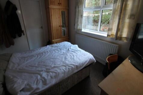 A cozy master bedroom with a neatly made bed, l...