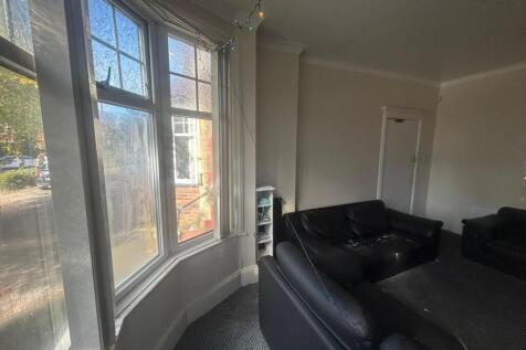 Bright and spacious living room with large wind...