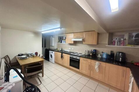 A well-maintained, well-lit kitchen with ample ...