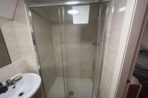 A well-maintained bathroom featuring a spacious...