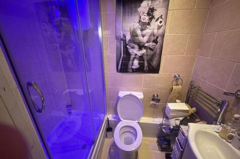 A clean, modern bathroom with a large shower, s...