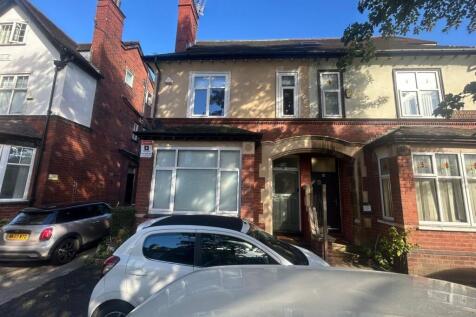 A charming exterior view of the front of a trad...