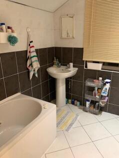 A functional bathroom featuring a bathtub, a si...