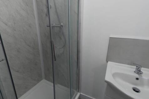 A clean and modern bathroom with a large bath a...