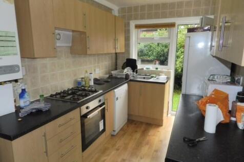 A clean and well-lit kitchen with modern cabine...