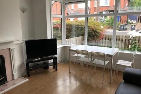 A bright and spacious living room with large wi...