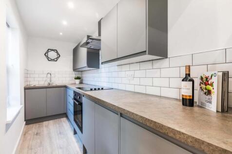 A modern, well-lit kitchen featuring a spacious...