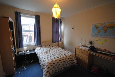A cozy double bedroom with a neatly made bed, n...