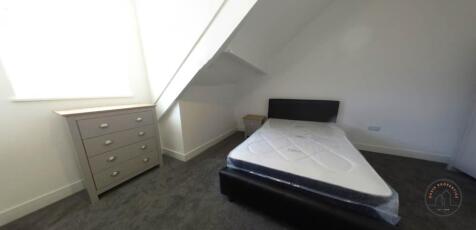 A well-maintained bedroom with a comfortable si...