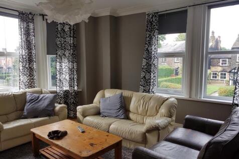 A spacious and inviting living room filled with...