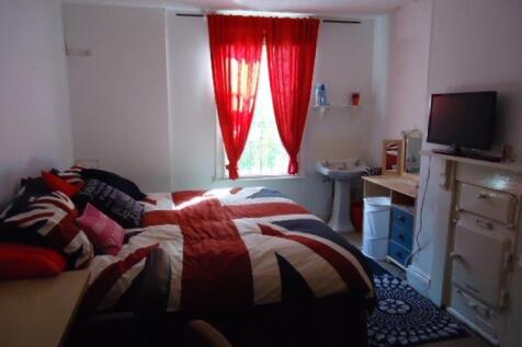 Spacious master bedroom featuring a comfortable...