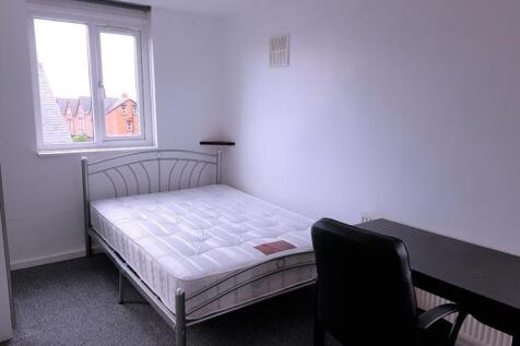 A tidy and well-lit single bedroom featuring a ...