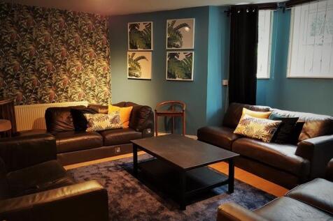 Warm, stylish living room with coordinating sof...