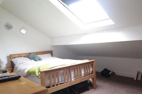 A cozy single bedroom with a comfortable bed, a...