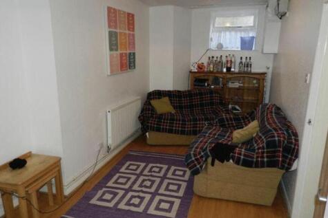 A cozy and well-lit living room featuring a com...