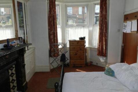 A cozy and well-maintained bedroom featuring a ...