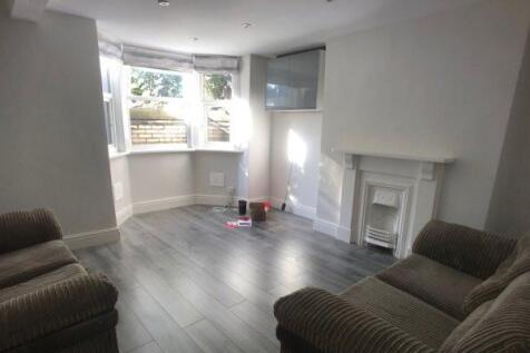 A bright, spacious living room with large windo...