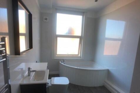 A modern and clean bathroom featuring a large b...