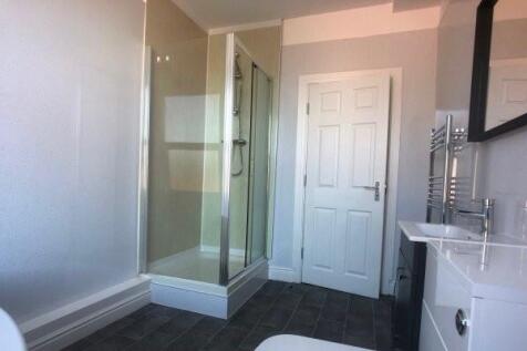 A clean and well-maintained bathroom with a gla...