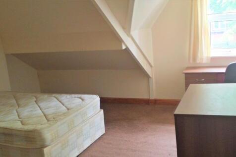 A bright and tidy living room with natural ligh...