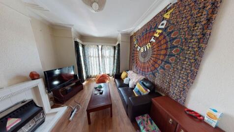 A spacious, well-lit living room featuring comf...