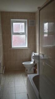 Bright and clean bathroom featuring a toilet an...