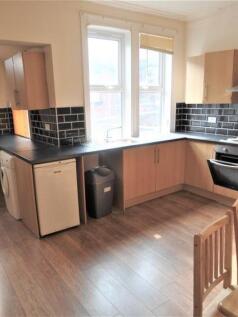 Bright and modern kitchen with ample natural li...