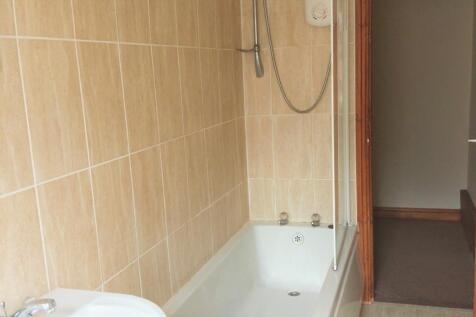 A clean, functional bathroom featuring a bathtu...