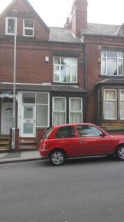 A traditional brick-fronted house with a white ...